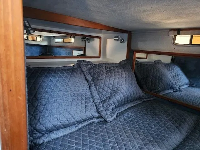 Slide: The Image of Cozy cabin interior of 1988 Sea Ray 340 Sundancer with blue quilted bedding. - 30