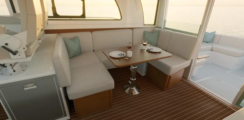 Slide: The Image of 2026 Back Cove 412 yacht interior with elegant dining area and ocean view. - 12