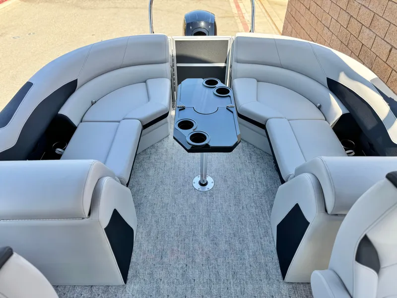 Slide: The Image of 2025 Berkshire 22RFX LE boat interior with gray seating and central table. - 15