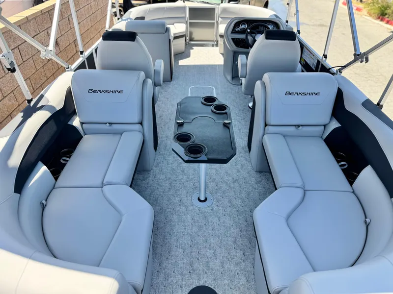 Slide: The Image of 2025 Berkshire 22RFX LE pontoon boat interior with plush seating and central table. - 19