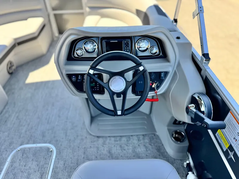 Slide: The Image of 2025 Berkshire 22RFX LE boat dashboard with steering wheel and control panel. - 21