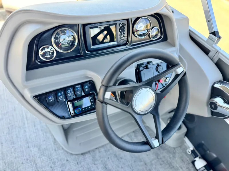 Slide: The Image of Steering console of 2025 Berkshire 22RFX LE boat with modern controls and gauges. - 22