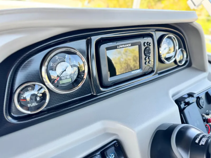 Slide: The Image of Dashboard of 2025 Berkshire 22RFX LE with gauges and Lowrance display. - 24