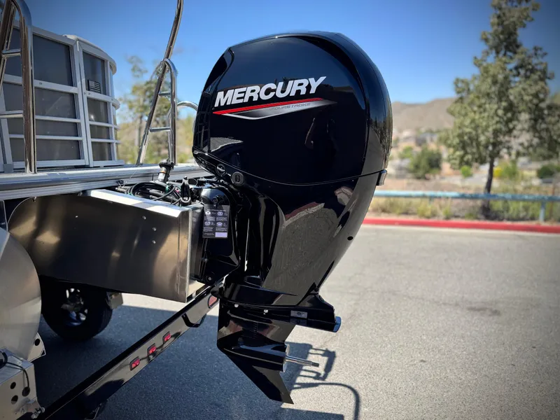 Slide: The Image of 2025 Berkshire 22RFX LE with Mercury outboard motor, parked outdoors on a sunny day. - 7