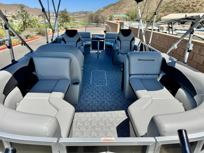 Slide: The Image of 2025 Berkshire 22RFX LE pontoon boat with luxurious seating and scenic mountain backdrop. - 8