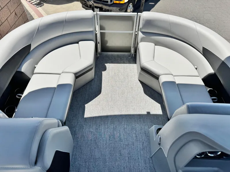 Slide: The Image of 2025 Berkshire 22RFX LE boat interior with gray seating and carpeted floor. - 9