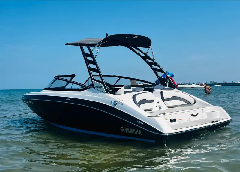 Slide: The Image of 2022 Yamaha Boats 195 S in water, sleek design, black and white color scheme. - 3