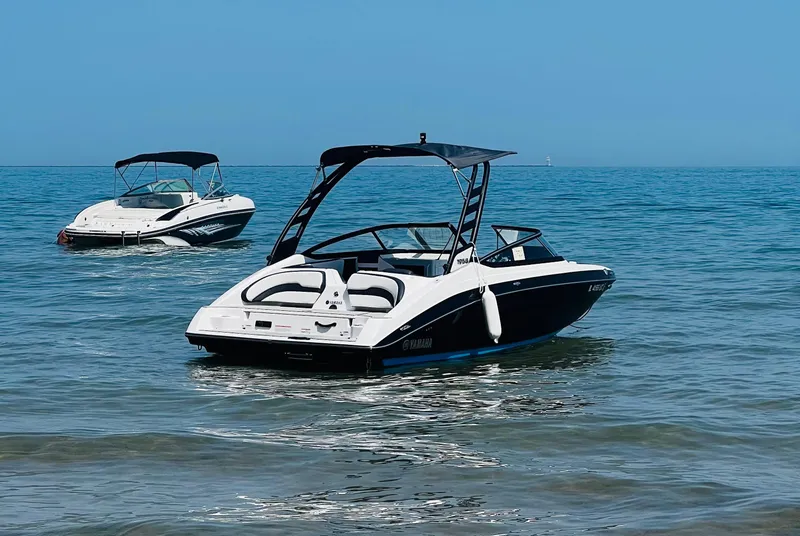 Slide: The Image of 2022 Yamaha Boats 195 S on calm ocean waters, showcasing sleek design and performance. - 6