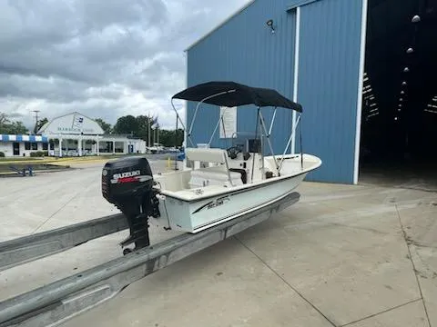 Slide: The Image of 2009 May-Craft 1700 Skiff with Suzuki outboard motor at marina entrance. - 10
