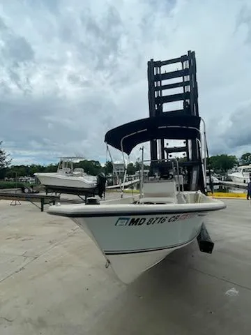 Slide: The Image of 2009 May-Craft 1700 Skiff boat on a dock with cloudy sky background. - 11