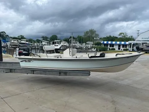 Slide: The Image of 2009 May-Craft 1700 Skiff boat on trailer at marina, cloudy sky background. - 4
