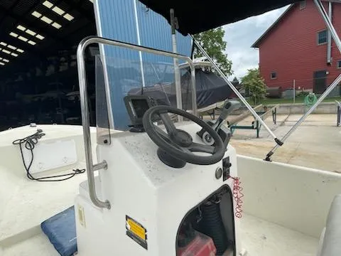 Slide: The Image of 2009 May-Craft 1700 Skiff boat interior with steering wheel and console. - 6