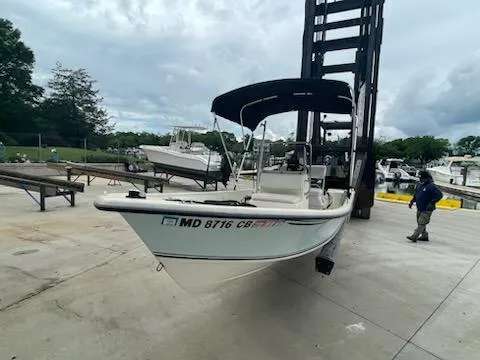 Slide: The Image of 2009 May-Craft 1700 Skiff boat on a lift at a marina. - 9