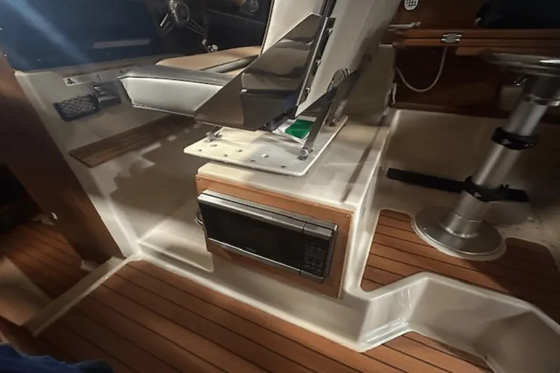 Slide: The Image of 2019 Ranger R27 LE interior with wood flooring and built-in microwave. - 11