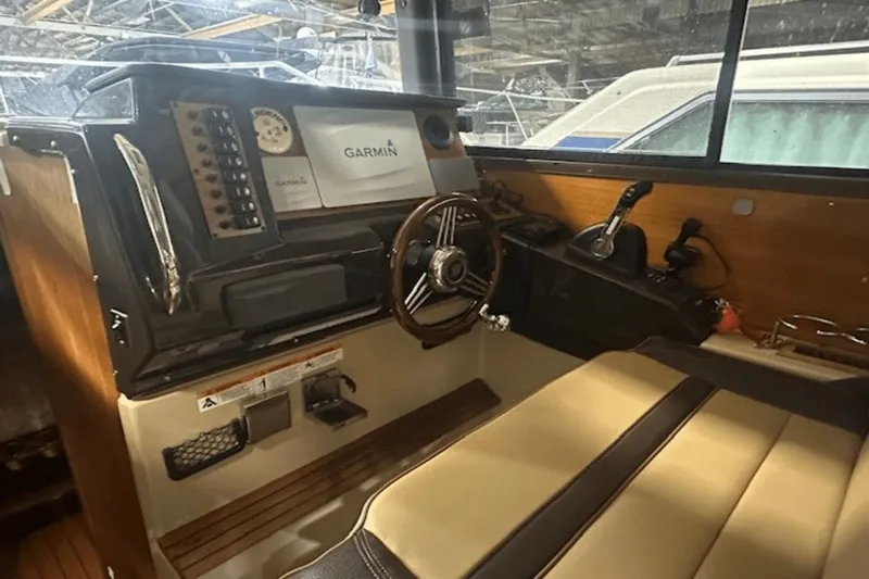 Slide: The Image of Interior of 2019 Ranger R27 LE boat with Garmin navigation system and steering wheel. - 13