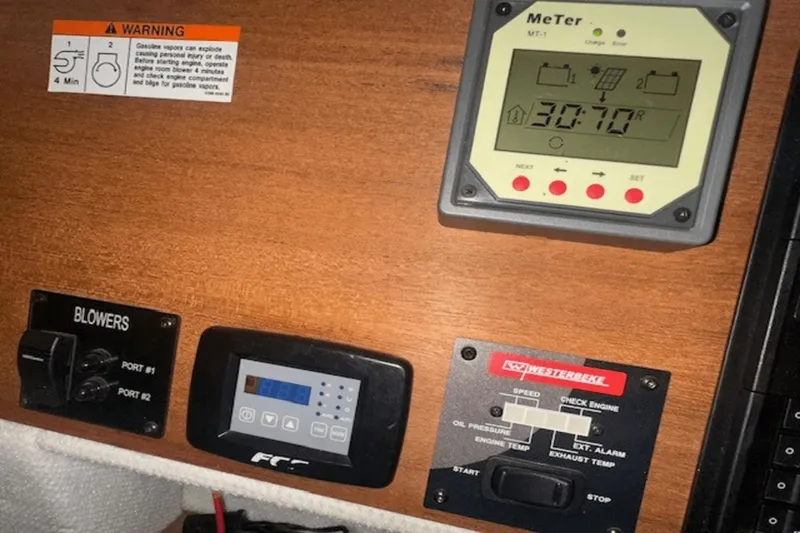 Slide: The Image of Control panel of a 2019 Ranger R27 LE boat with warning labels and meters. - 16