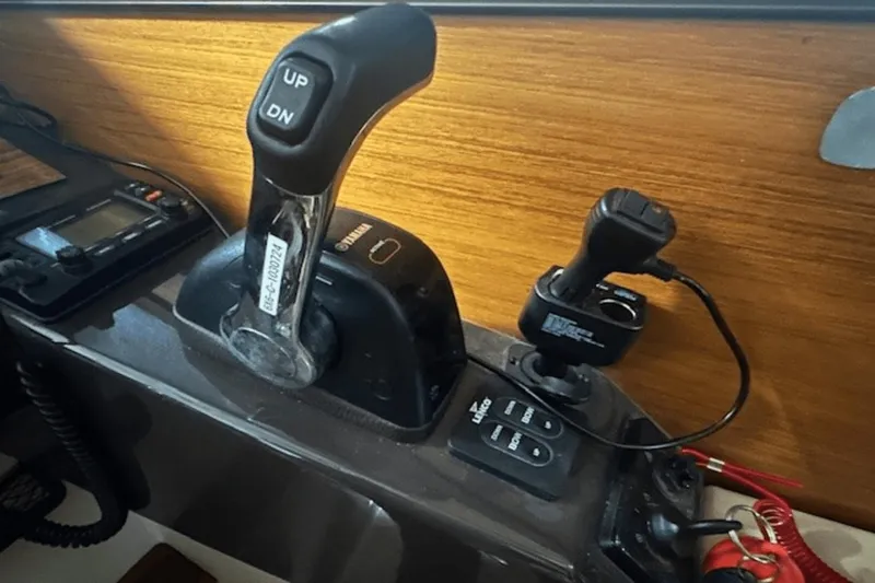 Slide: The Image of 2019 Ranger R27 LE boat controls with throttle and electronic panel. - 18
