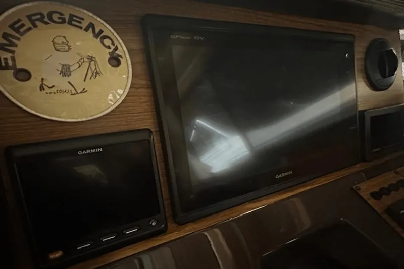 Slide: The Image of Dashboard of 2019 Ranger R27 LE with Garmin screens and emergency sign. - 20