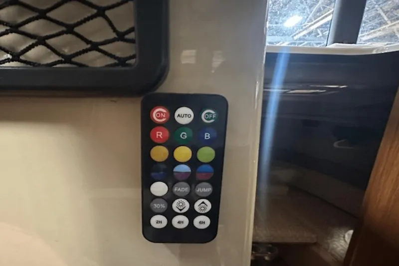 Slide: The Image of Remote control panel with various buttons in a 2019 Ranger R27 LE. - 22