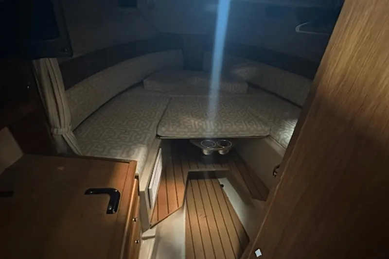 Slide: The Image of 2019 Ranger R27 LE cabin interior with cozy seating and wooden flooring. - 24