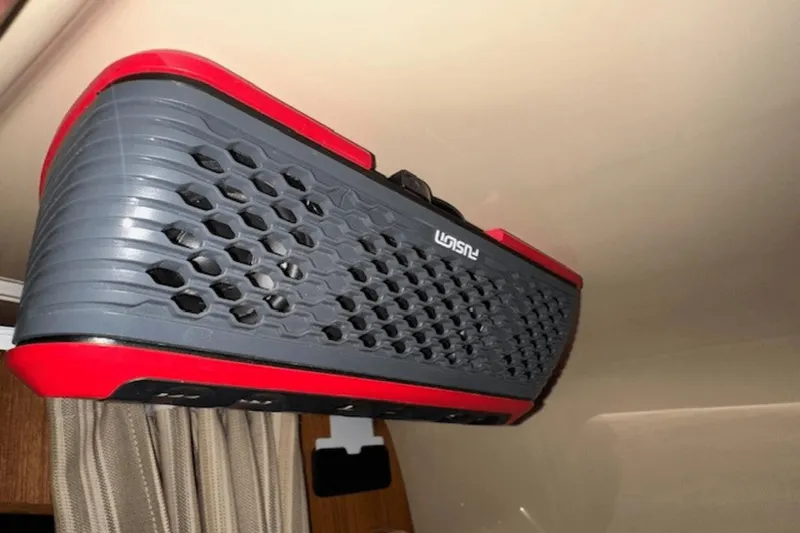 Slide: The Image of Red and gray Fusion speaker mounted inside a 2019 Ranger R27 LE boat. - 25
