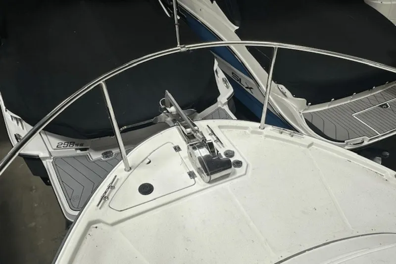 Slide: The Image of 2019 Ranger R27 LE boat bow with anchor, surrounded by other boats in storage. - 29