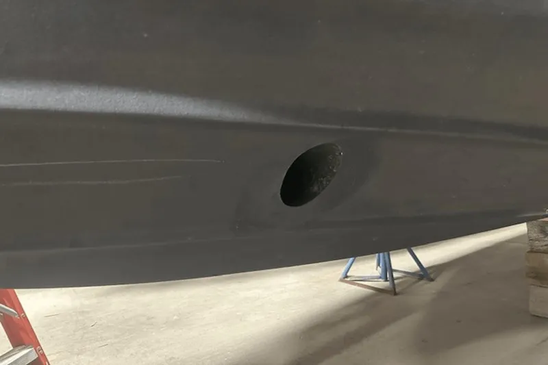 Slide: The Image of 2019 Ranger R27 LE hull with a circular hole, supported by stands. - 39