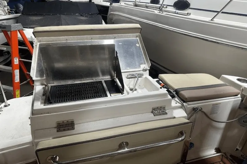 Slide: The Image of 2019 Ranger R27 LE boat with built-in grill and seating area. - 6