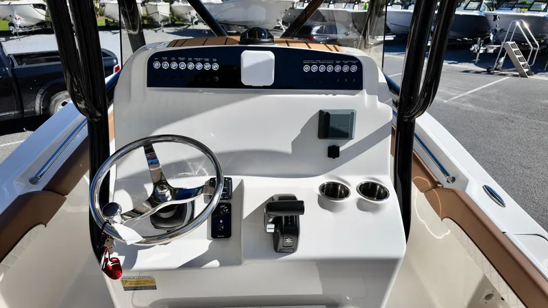 Slide: The Image of 2025 Pioneer 222 Islander boat dashboard with steering wheel and controls. - 13