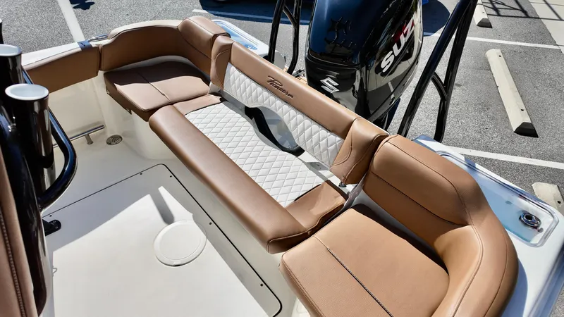 Slide: The Image of 2025 Pioneer 222 Islander boat interior with tan seating and white accents. - 15