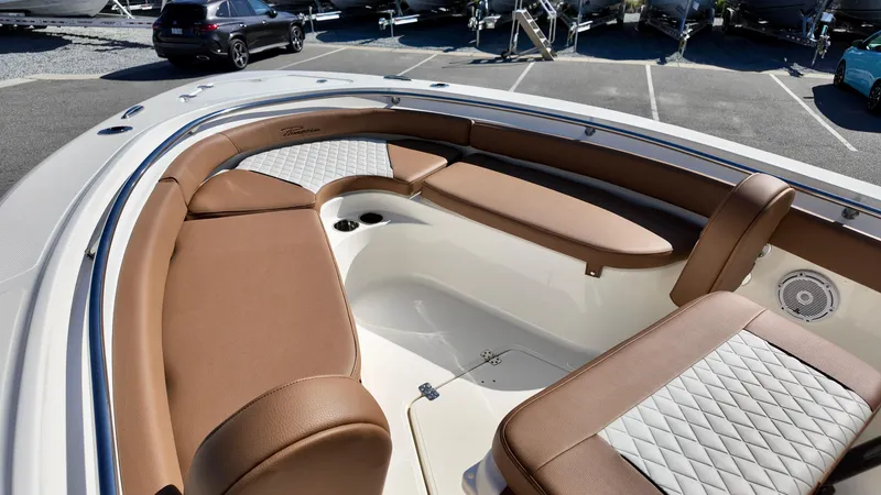 Slide: The Image of 2025 Pioneer 222 Islander boat interior with brown seating and white accents. - 19