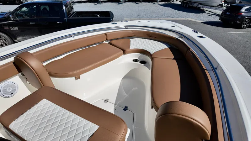 Slide: The Image of 2025 Pioneer 222 Islander boat interior with brown and white seating. - 20