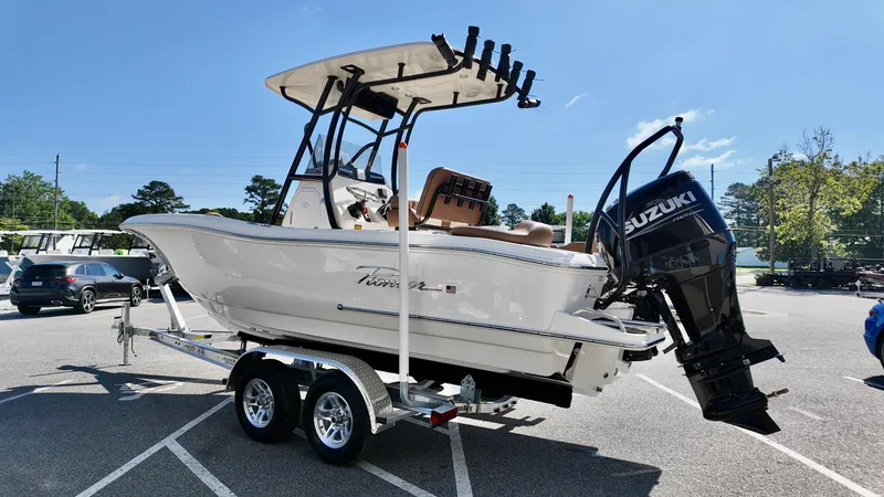 Slide: The Image of 2025 Pioneer 222 Islander boat with Suzuki outboard motor on trailer in parking lot. - 3