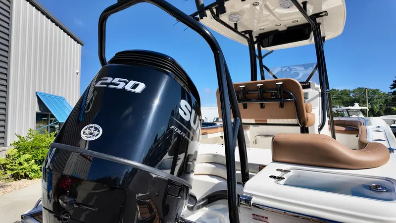 Slide: The Image of 2025 Pioneer 222 Islander boat with Suzuki 250 outboard motor, docked under clear blue sky. - 4