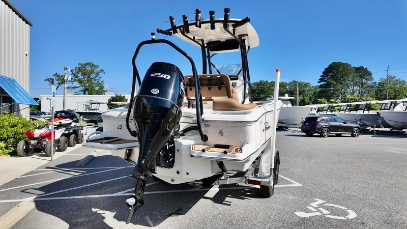 Slide: The Image of 2025 Pioneer 222 Islander boat with powerful outboard motor in a parking lot. - 5