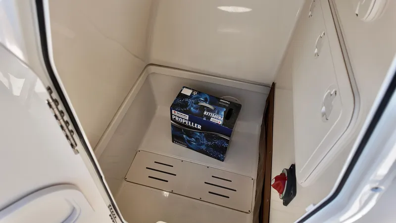 Slide: The Image of Storage compartment of 2025 Pioneer 222 Islander boat with a box inside. - 6