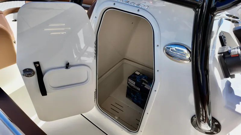 Slide: The Image of 2025 Pioneer 222 Islander boat storage compartment with open door. - 7