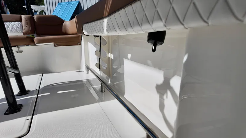 Slide: The Image of 2025 Pioneer 222 Islander boat interior with cushioned seating and sleek white finish. - 8