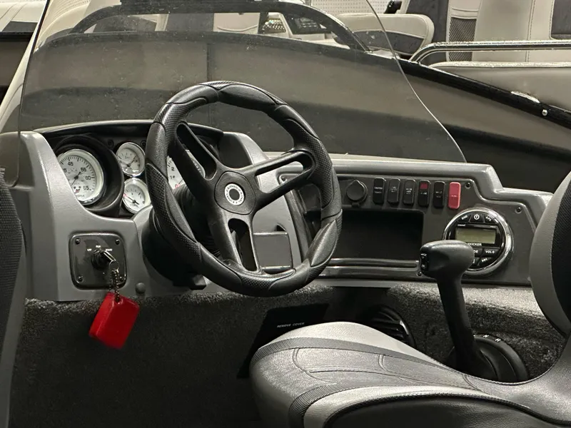 Slide: The Image of 2017 Lund 1675 Impact SS boat dashboard with steering wheel and control panel. - 10