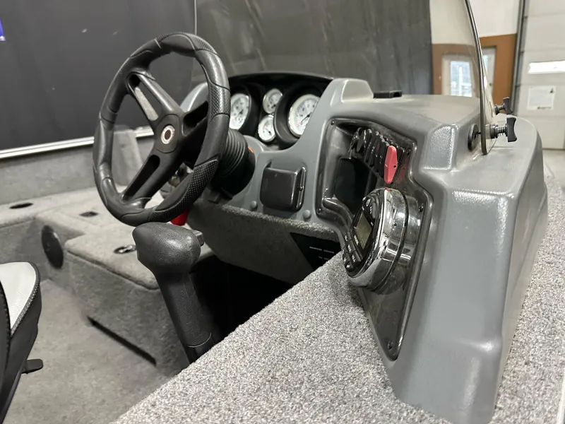 Slide: The Image of 2017 Lund 1675 Impact SS boat dashboard with steering wheel and instrument panel. - 11