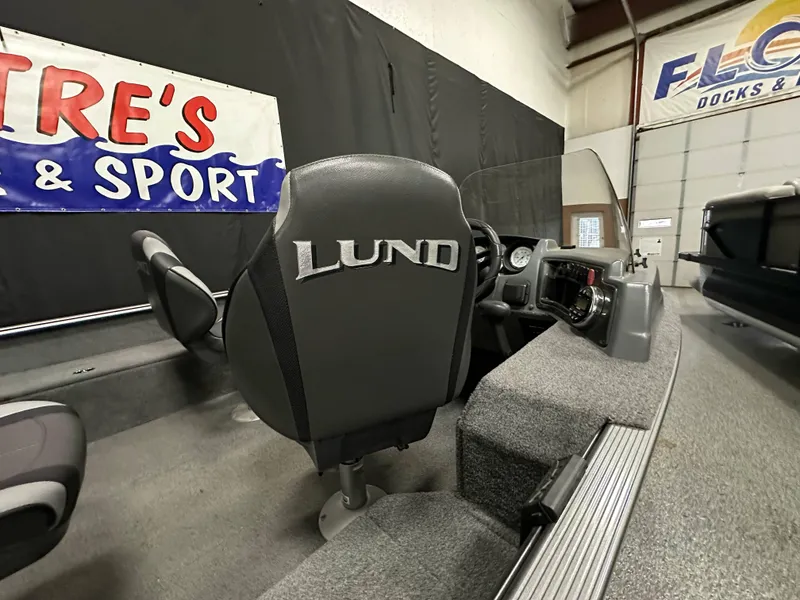 Slide: The Image of 2017 Lund 1675 Impact SS boat interior with branded seat and dashboard. - 14