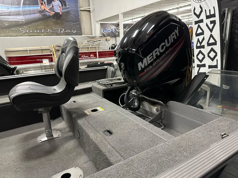 Slide: The Image of 2017 Lund 1675 Impact SS boat interior with Mercury outboard motor in showroom. - 15