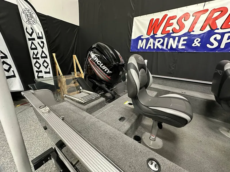 Slide: The Image of 2017 Lund 1675 Impact SS boat interior with Mercury engine at Westrum Marine & Sport display. - 16
