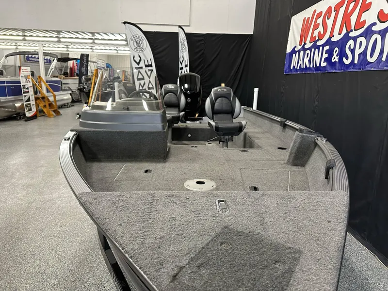 Slide: The Image of 2017 Lund 1675 Impact SS fishing boat displayed at a marine sports showroom. - 6