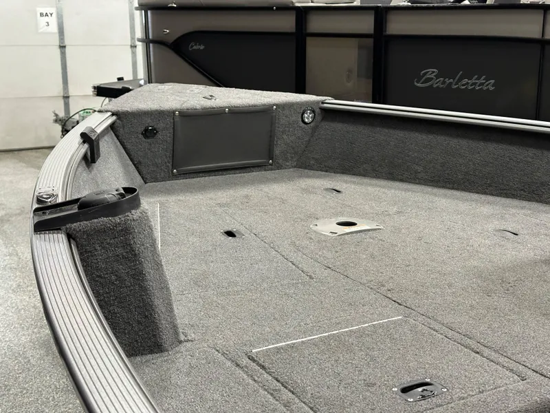 Slide: The Image of 2017 Lund 1675 Impact SS boat interior with gray carpeted deck. - 7