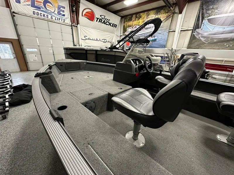 Slide: The Image of 2017 Lund 1675 Impact SS boat interior with seating and steering console in showroom. - 9