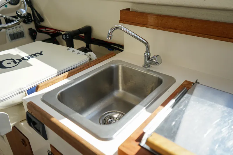 Slide: The Image of Compact kitchen sink in 2016 C-Dory 22' Cruiser boat interior. - 11