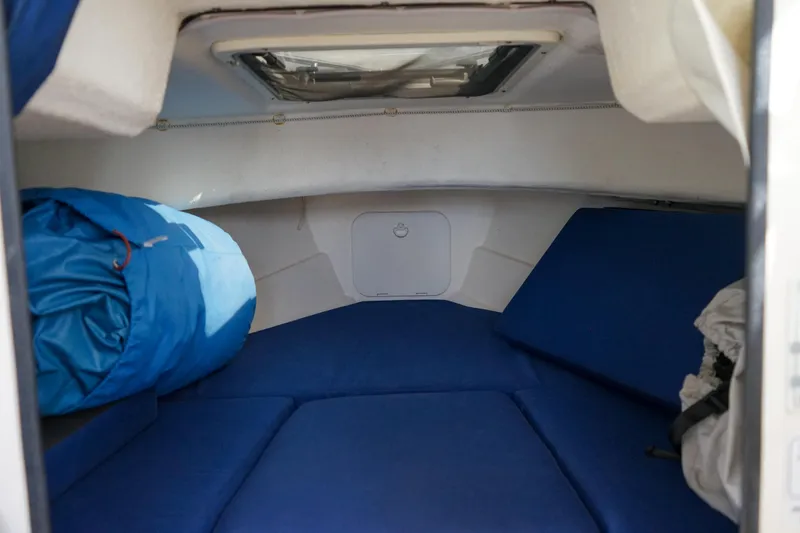 Slide: The Image of Interior cabin of 2016 C-Dory 22' Cruiser with blue cushions and sleeping bag. - 15