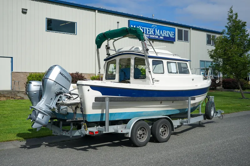 Slide: The Image of 2016 C-Dory 22' Cruiser on trailer outside marine center. - 3