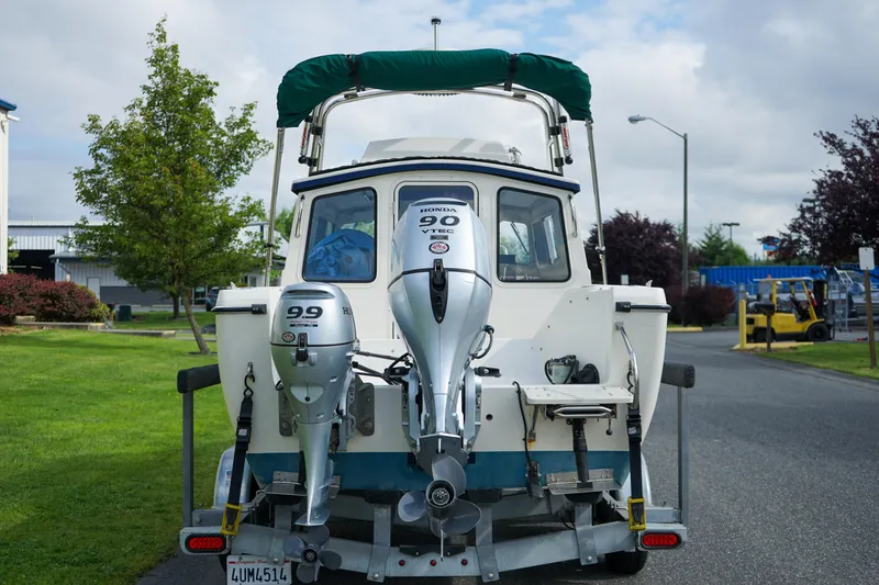 Slide: The Image of 2016 C-Dory 22' Cruiser boat with dual outboard motors on a trailer. - 4